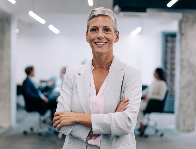 Businesswoman standing in office smiling