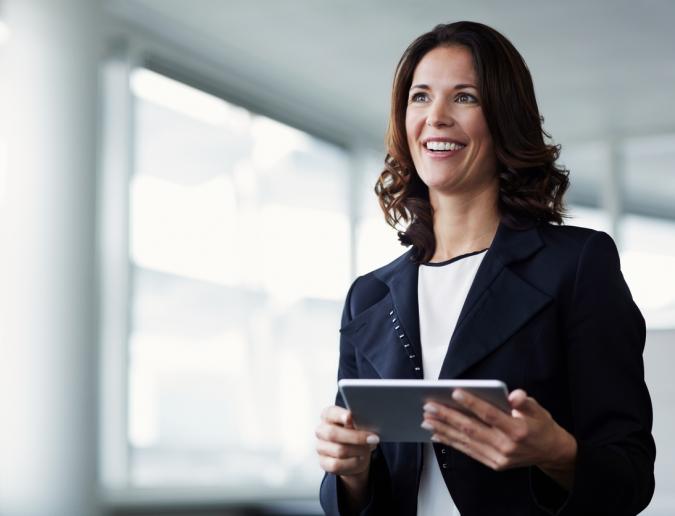 Businesswoman standing with tablet in hand